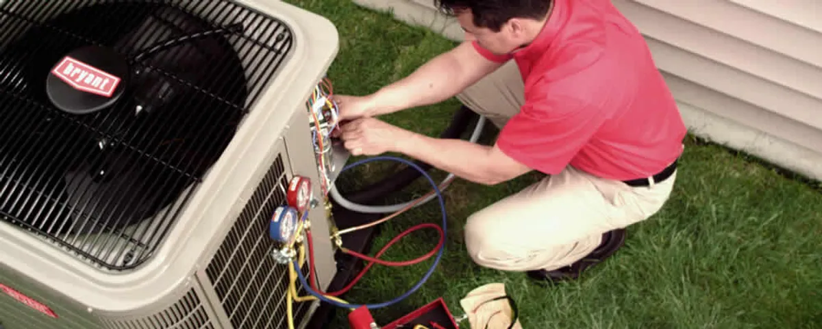 HVAC technician servicing an outdoor air conditioner unit in Wellesley, MA